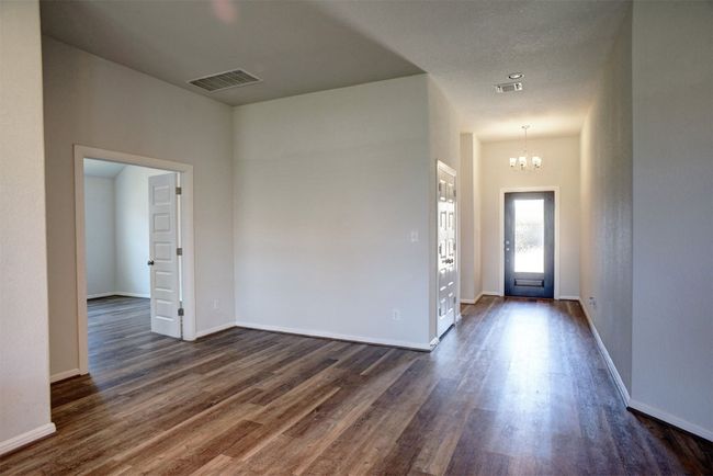 Entrance foyer with baseboards, visible vents, an inviting chandelier, and dark wood-style floors | Image 6