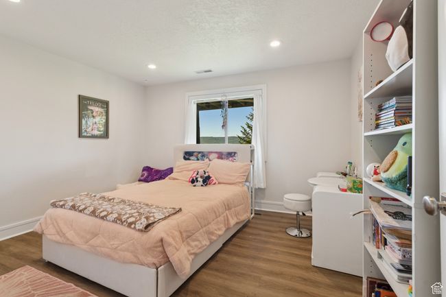 Bedroom featuring wood finished floors and recessed lighting | Image 28
