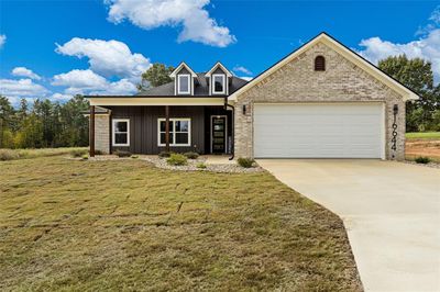 View of front home with a garage and a front yard | Image 1