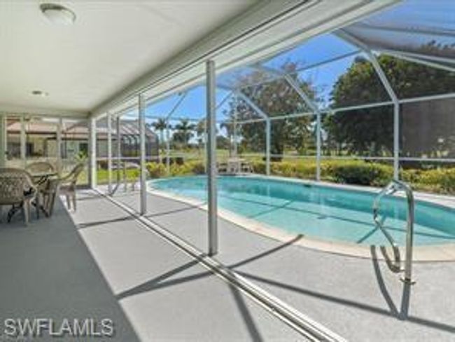 View of pool featuring glass enclosure and a patio area | Image 21