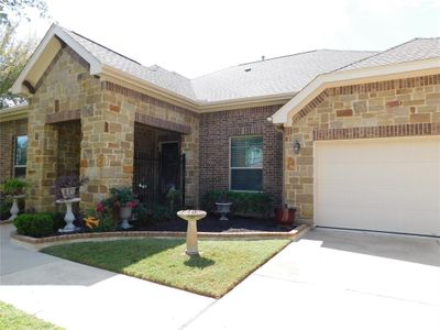 Front of home. Home is complimented with complete rock and brick exterior. | Image 1