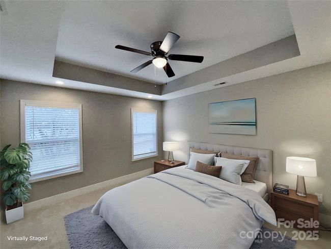 Primary bedroom 14'2 x 12'4" with ensuite bath and walk in closet. | Image 7