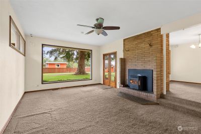 The pellet stove is a newer added feature to this wonderfu home. The french doors lead you out to the most charming patio surrounded by brick planter boxes. | Image 3