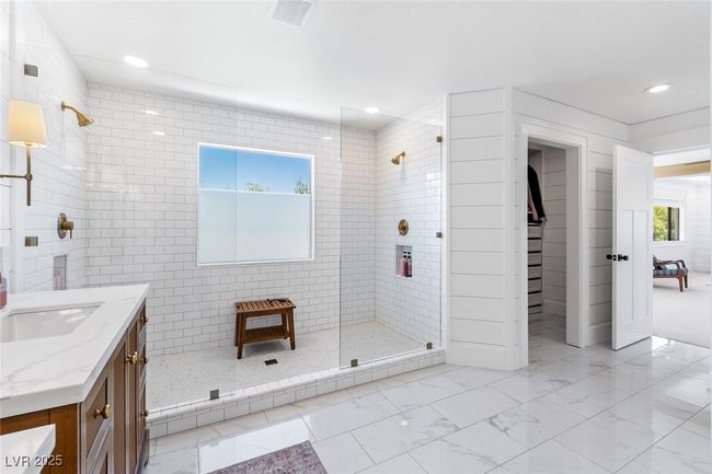 Bathroom featuring vanity, a tile shower, marble finish floor, and recessed lighting | Image 29