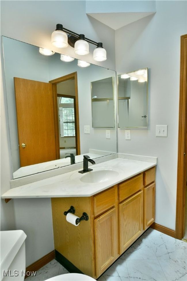 Half bath featuring vanity and marble look tiles | Image 34