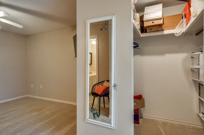 Walk in closet with ceiling fan and carpet flooring | Image 19
