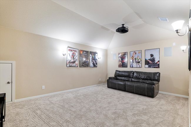 Cinema featuring carpet floors, lofted ceiling, baseboards, and a ceiling fan | Image 23