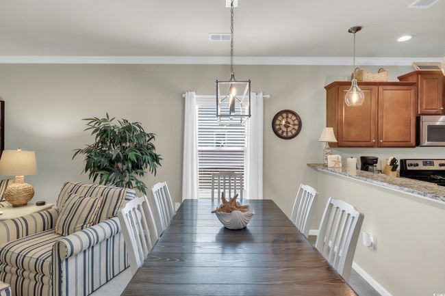 Dining area with ornamental molding and recessed lighting | Image 6