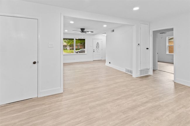 Empty room with recessed lighting, light wood-style floors, baseboards, and ceiling fan | Image 20
