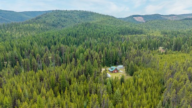 View of mountain backdrop featuring a heavily wooded area | Image 7