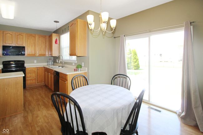 Enjoy the convenience and flow of this eat-in kitchen. Plenty of room for your preferred table setup and direct access to the patio mean effortless indoor-outdoor living and easy grilling. | Image 9