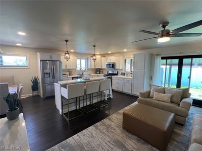 Living room featuring sink, ceiling fan, and dark hardwood / wood-style flooring | Image 3