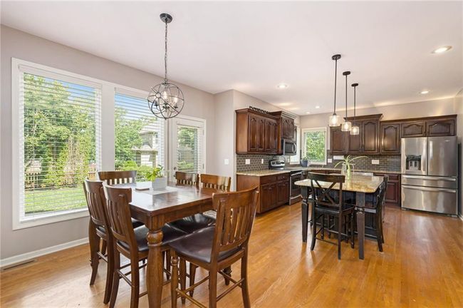Dining room with a chandelier, light wood-style flooring, baseboards, and recessed lighting | Image 13