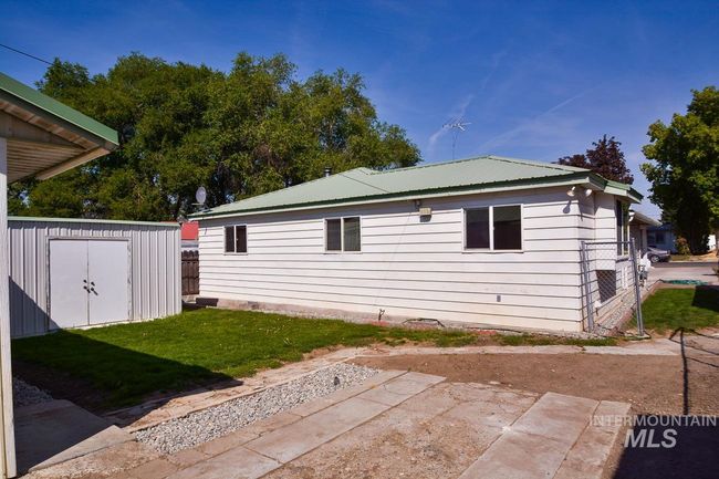 View of home's exterior with a shed, a lawn, and a patio area | Image 39