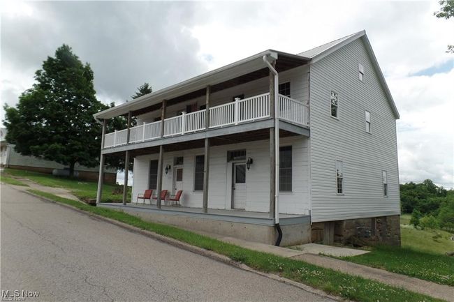 Multi unit property featuring covered porch and a balcony | Image 4