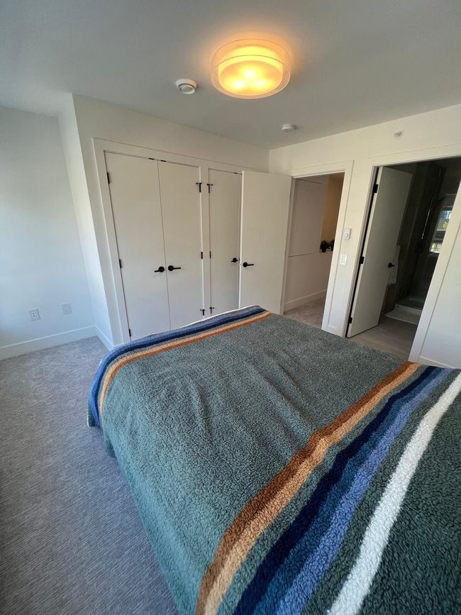 Carpeted bedroom featuring multiple closets and baseboards | Image 19