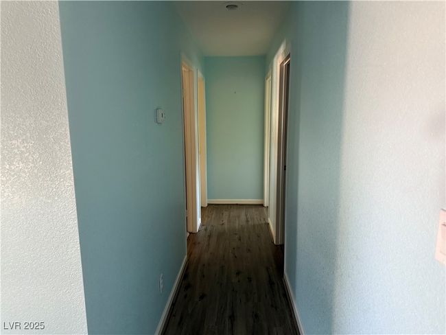Hall featuring dark wood-style flooring and baseboards | Image 15