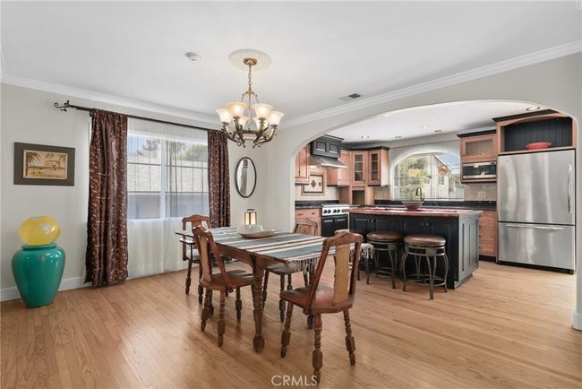 Formal dining area flows nicely from living space to open kitchen | Image 11