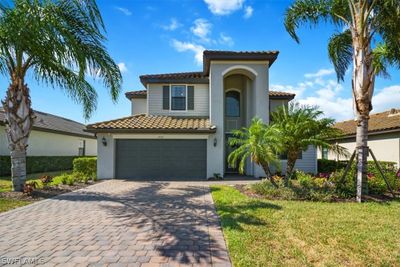 Mediterranean / spanish house featuring a garage and a front yard | Image 2