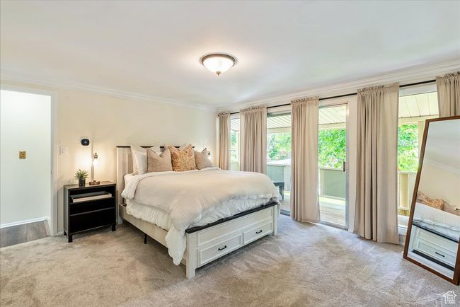 Bedroom featuring crown molding, carpet, and access to outside | Image 33