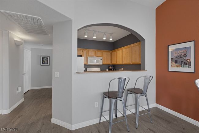 Kitchen with visible vents, baseboards, wood finished floors, and white appliances | Image 6