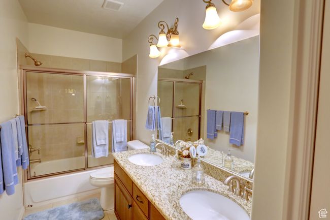 Full bath with a sink, visible vents, double vanity, and combined bath / shower with glass door | Image 32