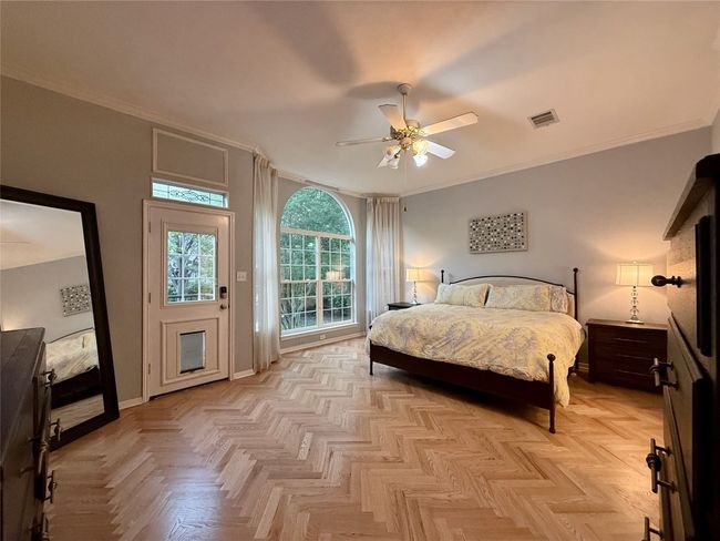 Bedroom with baseboards, ornamental molding, ceiling fan, and visible vents | Image 21