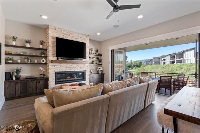 Main level living room with balcony view | Image 4