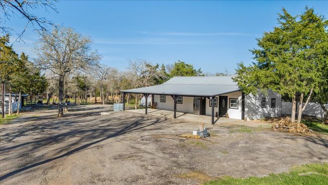 View of front of home with metal roof, aphalt driveway, and an attached carport | Image 23