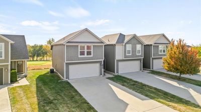 View of front of home featuring a front yard and a garage | Image 3