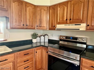 Kitchen featuring stainless steel range with electric cooktop | Image 3