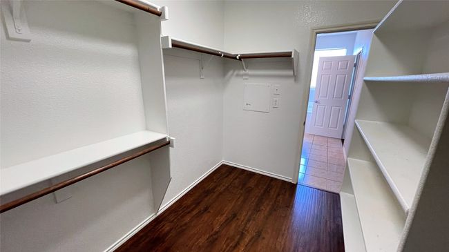 Walk in closet with dark wood-style floors | Image 20