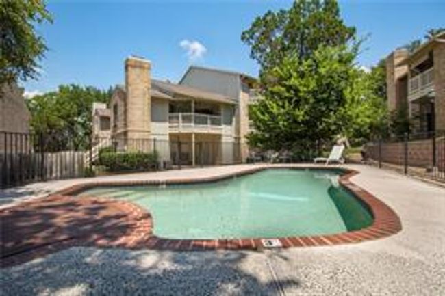 View of swimming pool featuring fence and a patio area | Image 29