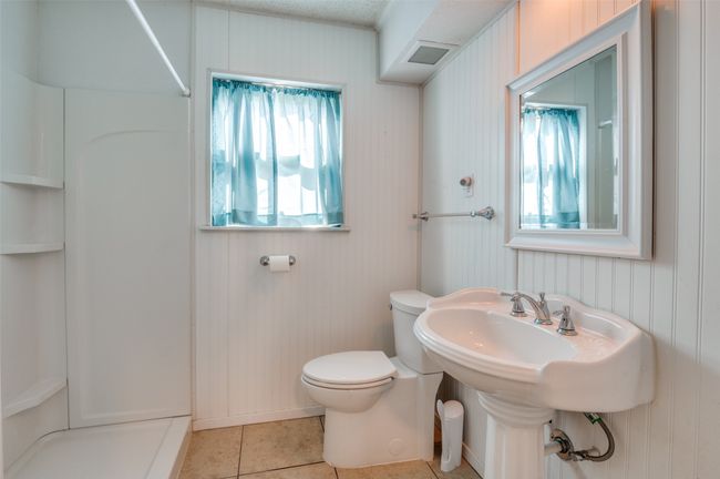 Bathroom featuring toilet, tile patterned flooring, and a shower | Image 19