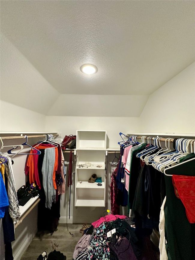 Spacious closet with lofted ceiling and carpet | Image 35