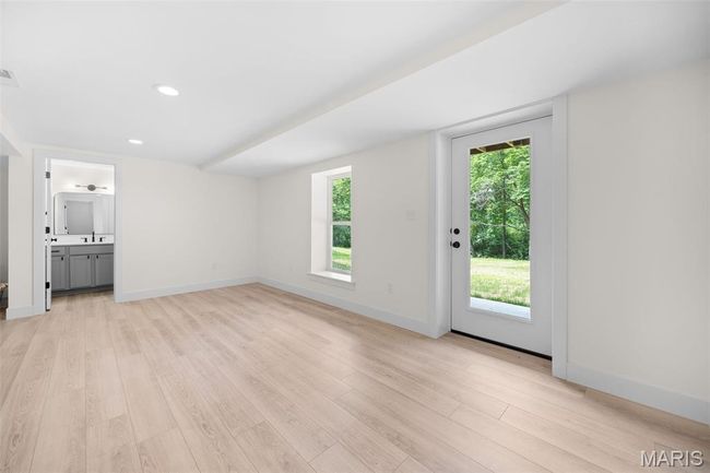 Unfurnished living room featuring light wood-style flooring and recessed lighting | Image 38