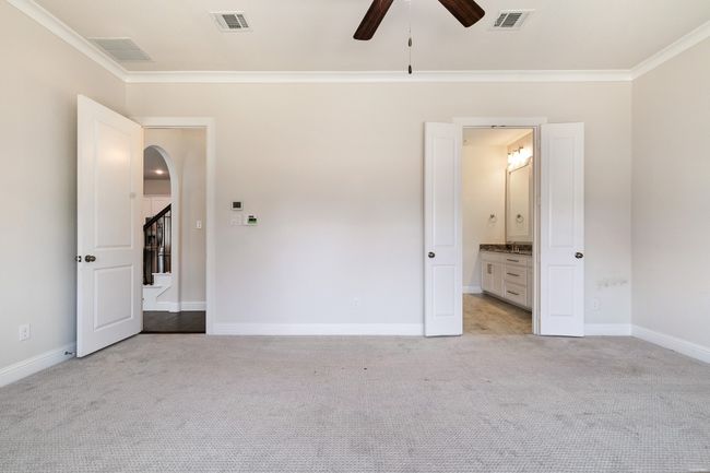 Unfurnished bedroom with ornamental molding, light colored carpet, and visible vents | Image 17