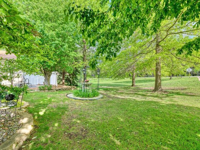 With this end unit twin home you have a large outdoor green area adjacent to the home that is owned by the association. | Image 25