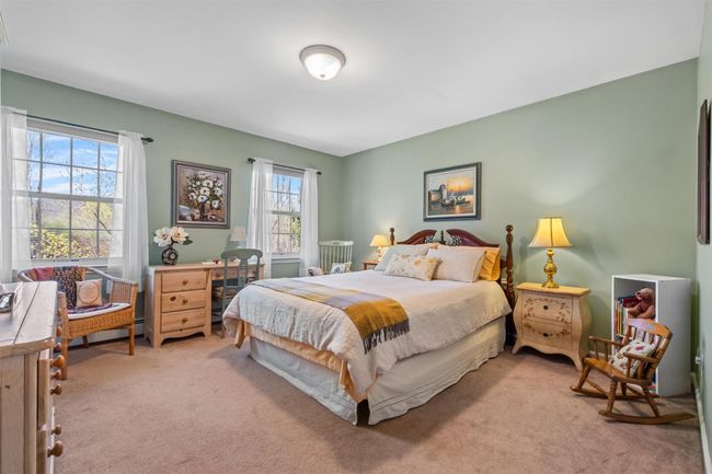 Bedroom #1 with carpet and several windows. | Image 21
