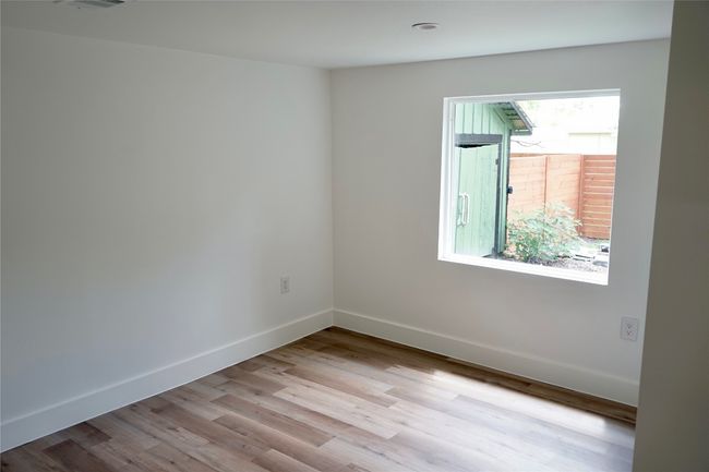 Spare room with wood finished floors and baseboards | Image 9