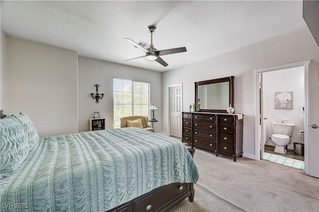 Carpeted bedroom with ensuite bathroom and ceiling fan | Image 15