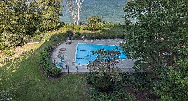 View of swimming pool featuring a water view and a lawn | Image 23