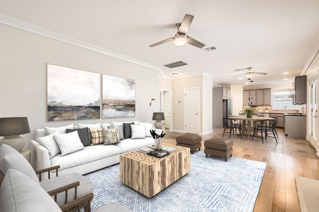 Living room with ceiling fan, ornamental molding, visible vents, and light wood-style flooring | Image 13