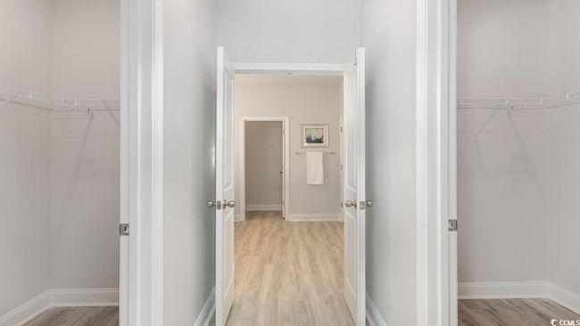 Bedroom featuring a tray ceiling and light hardwood / wood-style floors | Image 22