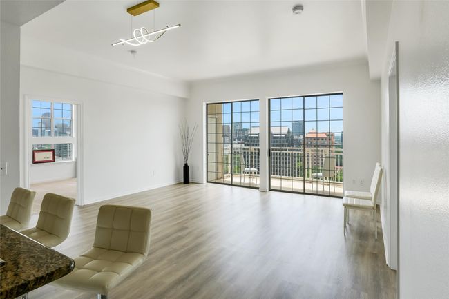 Unfurnished living room with wood finished floors and a chandelier | Image 15