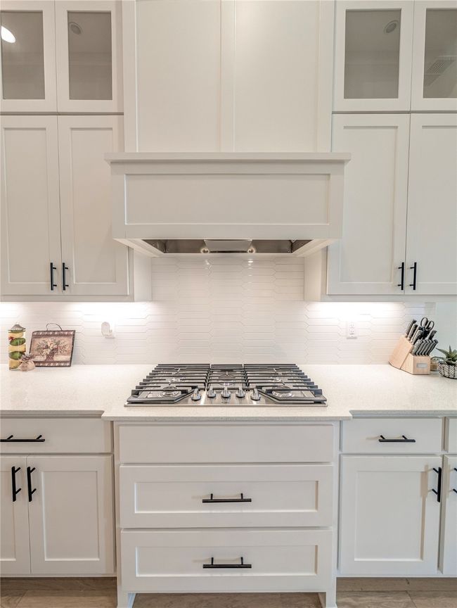 Kitchen featuring white cabinetry and light countertops | Image 11