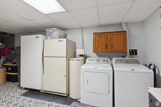 Washroom featuring cabinet space and separate washer and dryer | Image 22