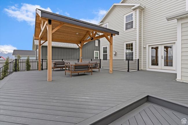 Wooden deck featuring a gazebo, an outdoor hangout area, and french doors | Image 36