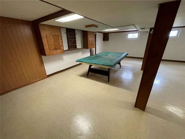 Game room with wood walls, visible vents, and baseboards | Image 33