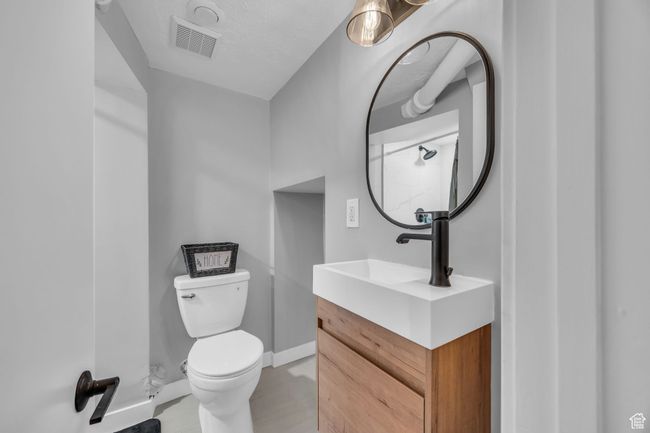 Bathroom with toilet, vanity, and baseboards | Image 22